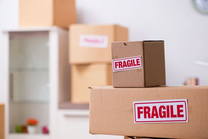 A stack of cardboard boxes with fragile stickers on them.