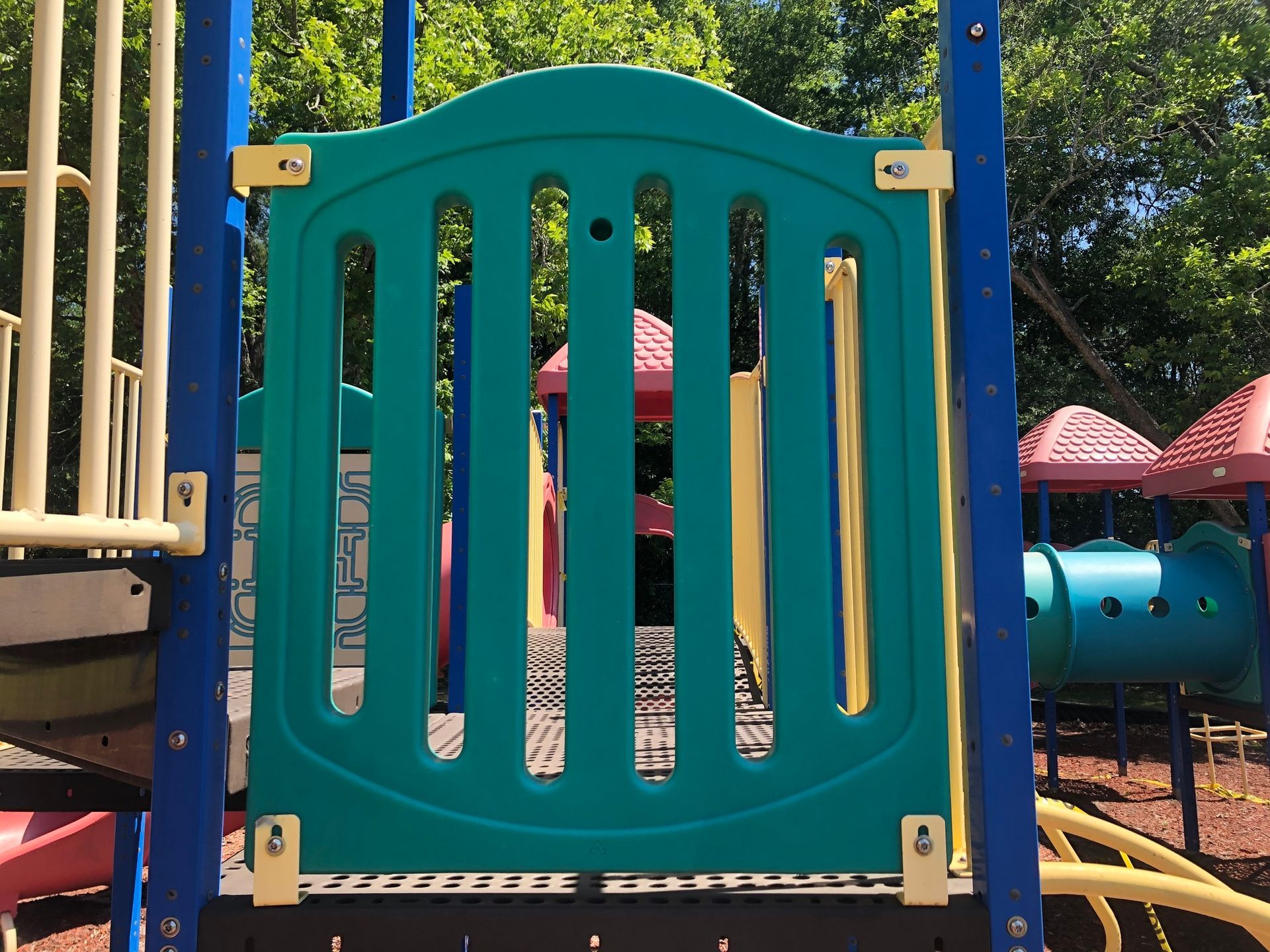 A playground with a blue gate that looks like a fence