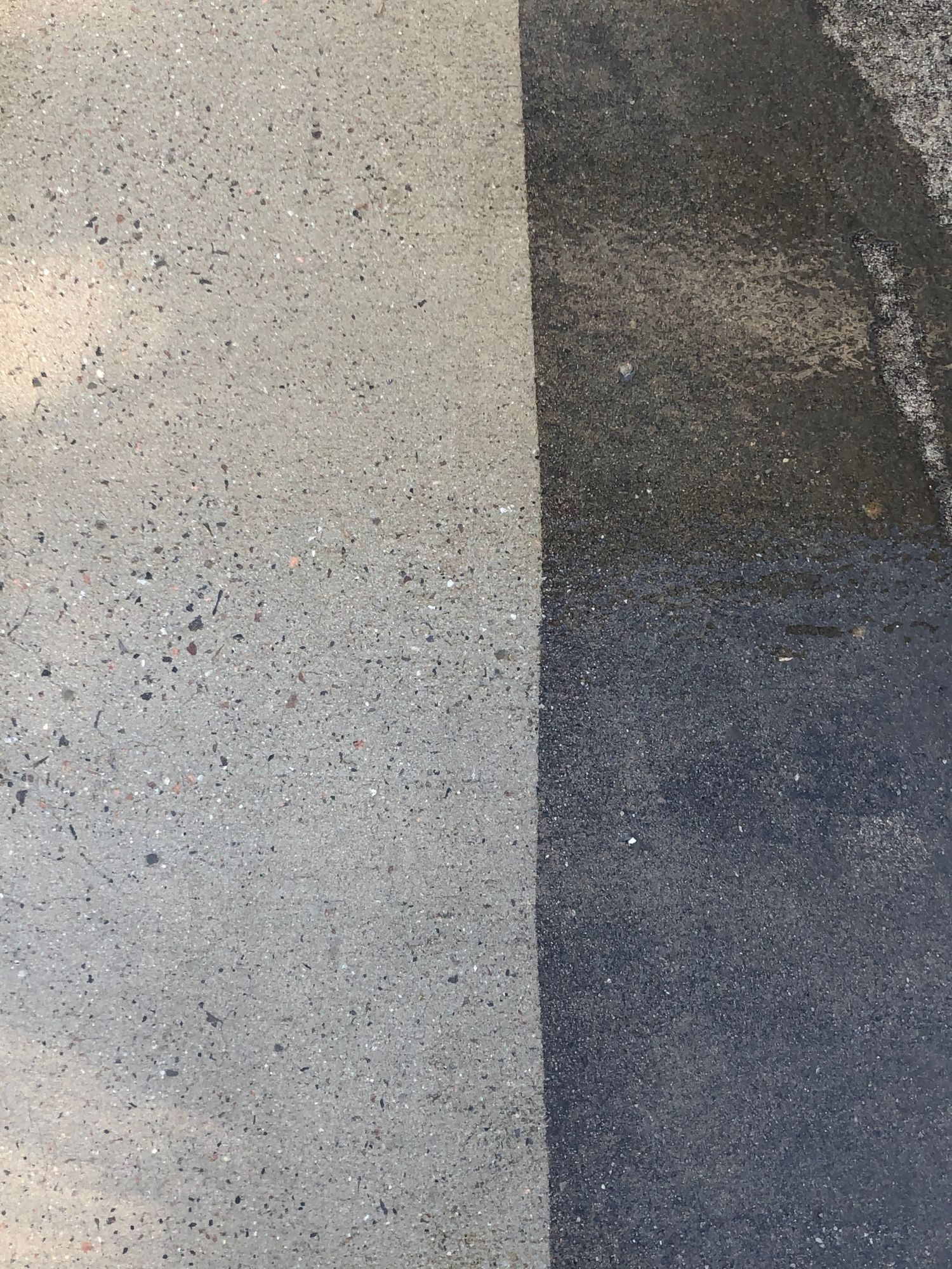 A close up of a gray and black concrete surface.