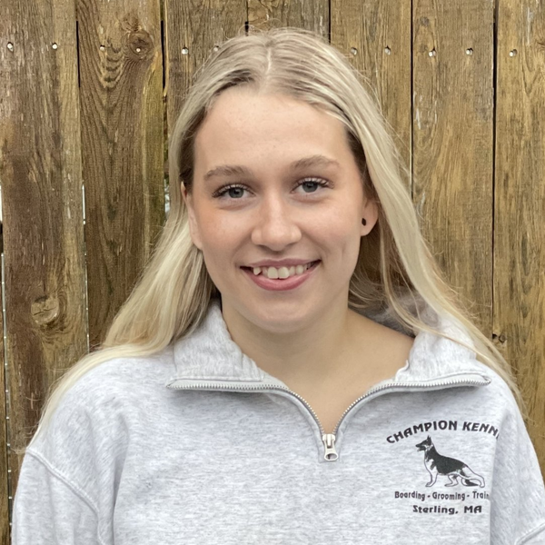 A woman wearing a champion kern sweatshirt smiles for the camera.