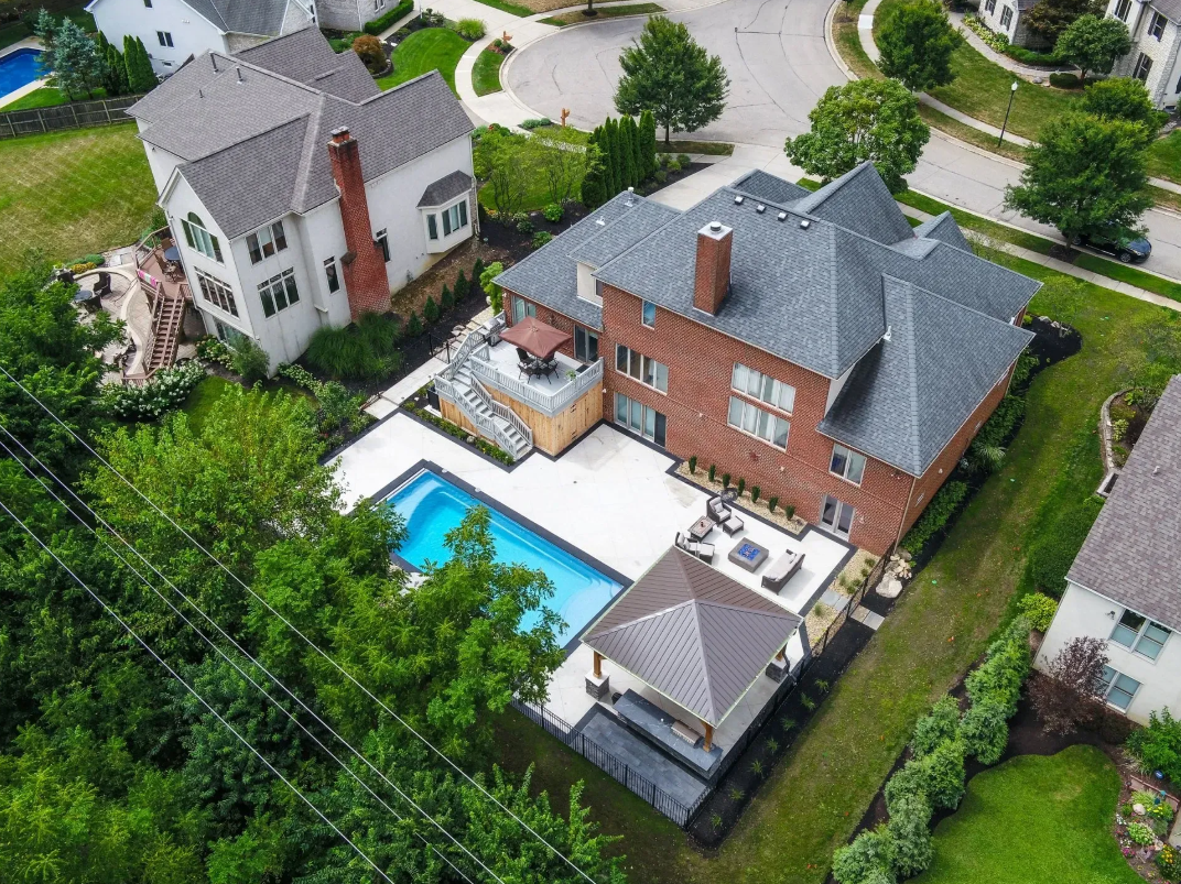 Serene aerial view of a residential property featuring a backyard swimming pool