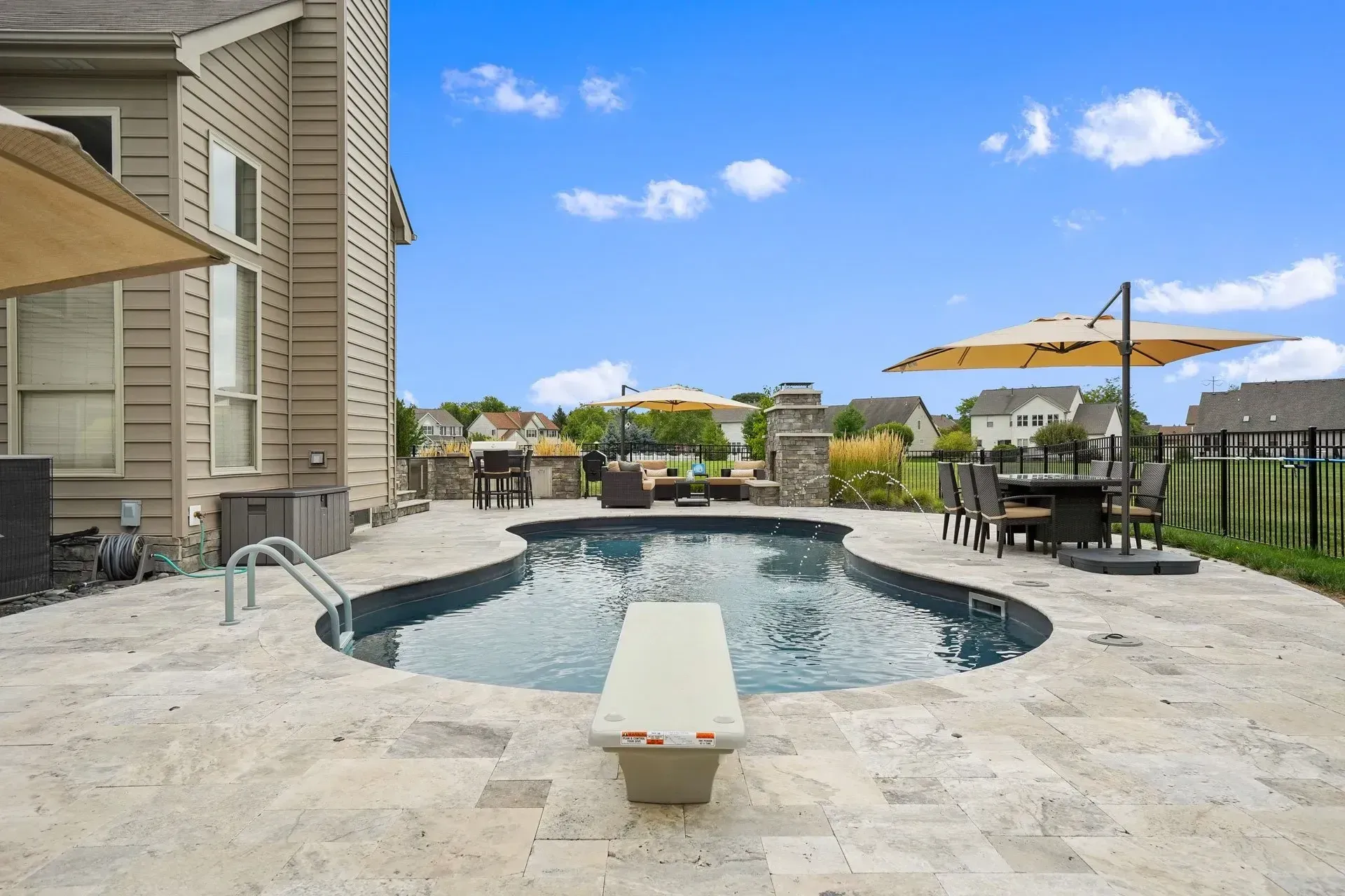 There is a diving board in the middle of the pool.
