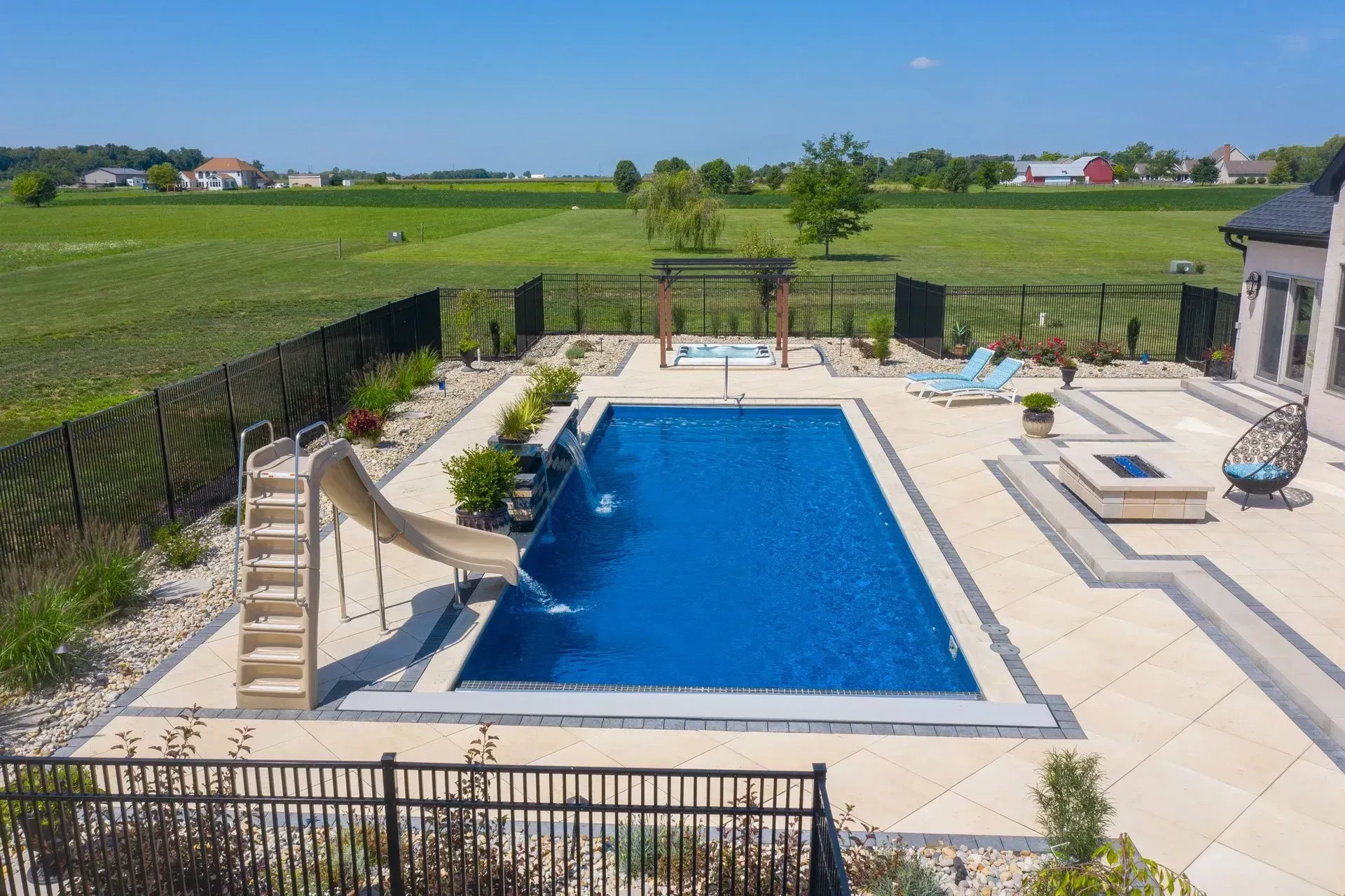An aerial view of a large swimming pool with a slide.