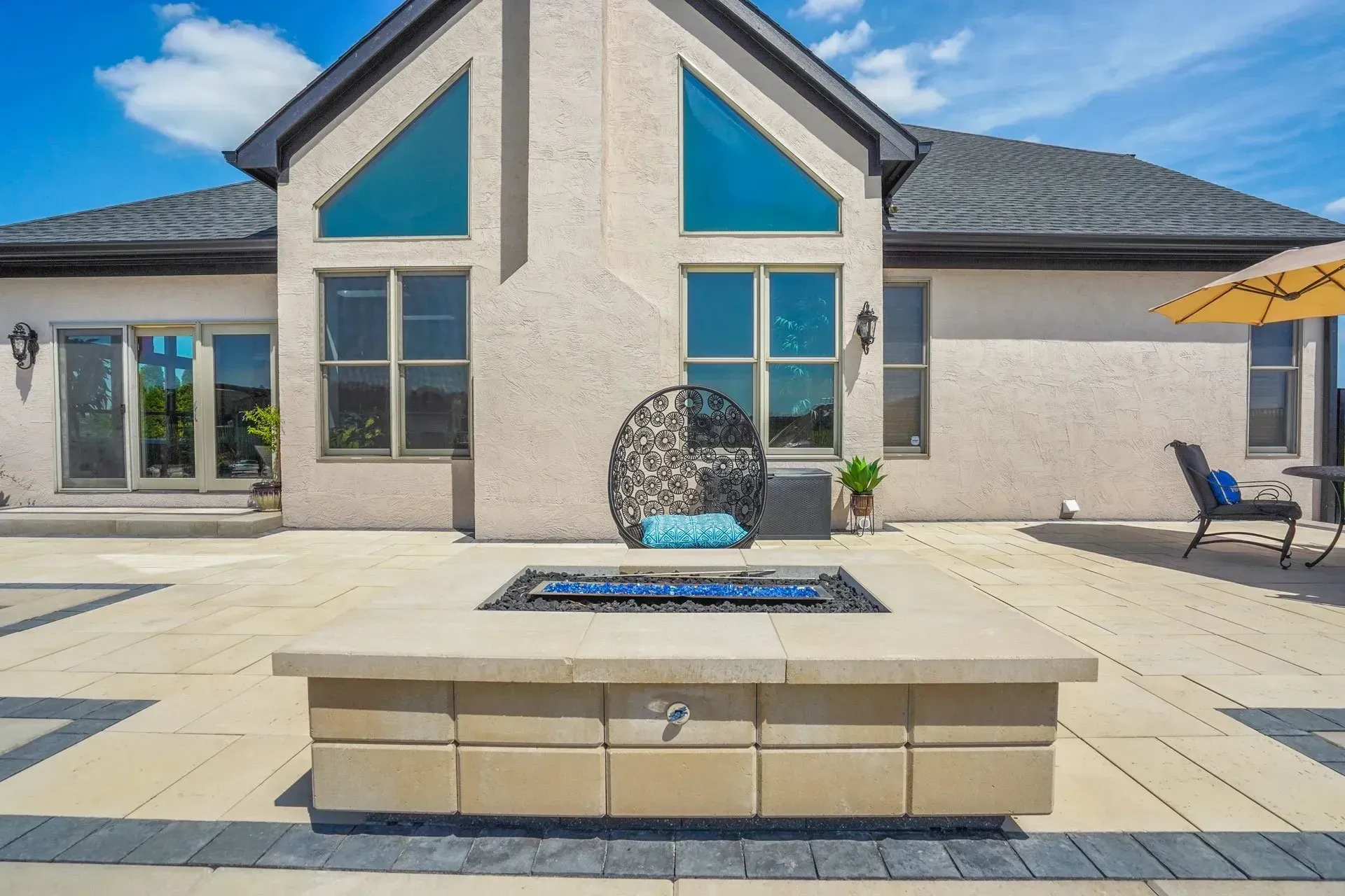A large house with a fire pit in front of it
