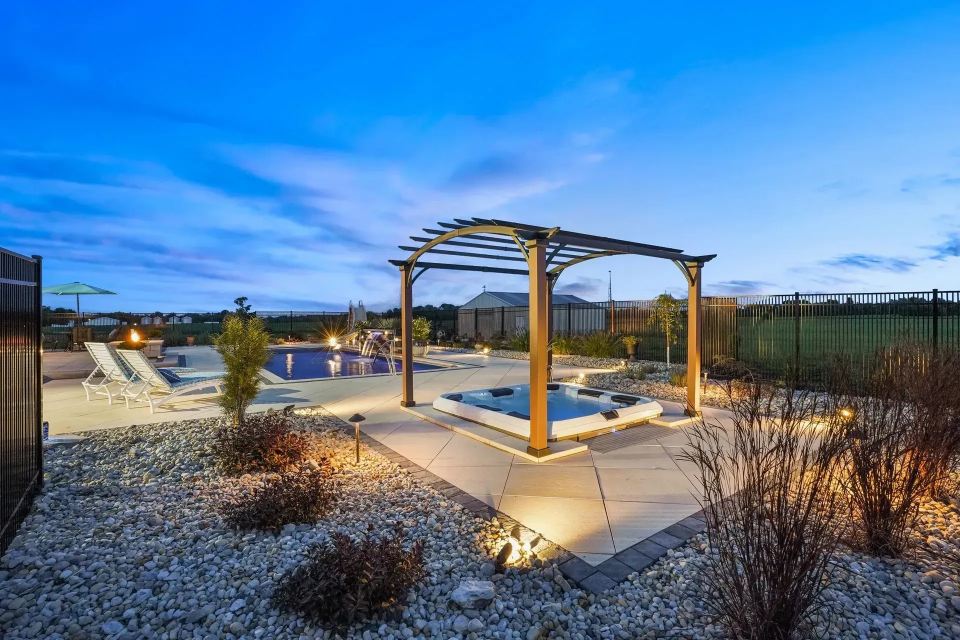 A large swimming pool with a pergola in the middle of it.