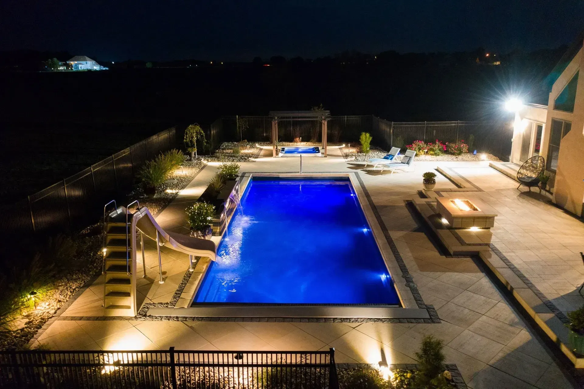 An aerial view of a large swimming pool at night.