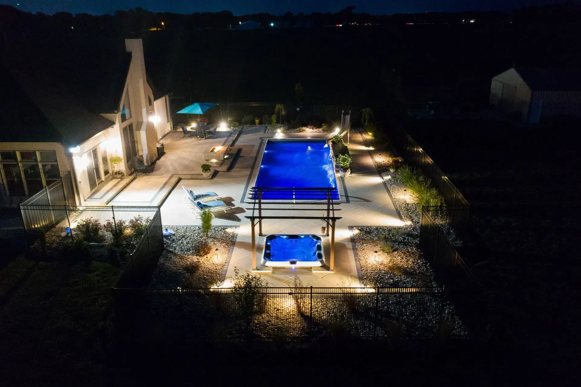 An aerial view of a large swimming pool at night.