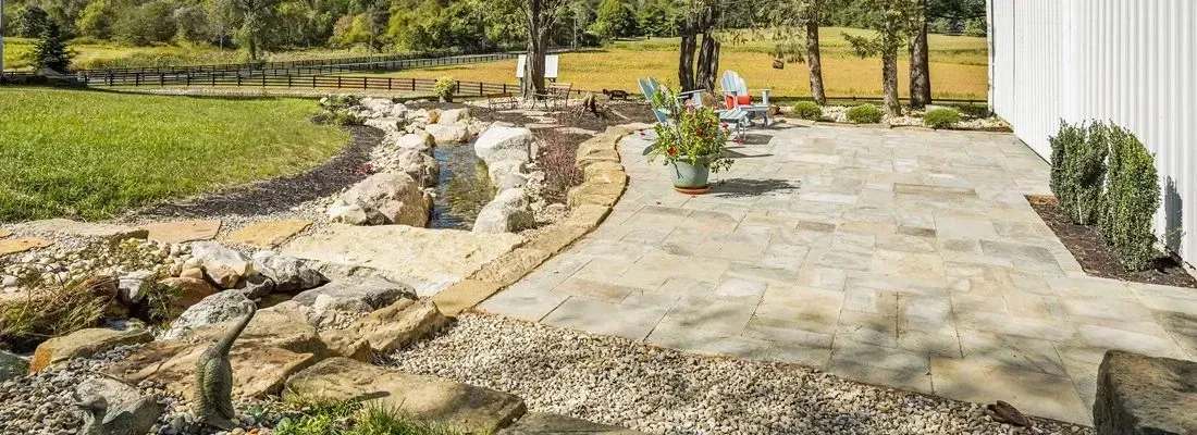 A beautiful natural stone patio with a rustic charm, perfect for outdoor gatherings and relaxation.