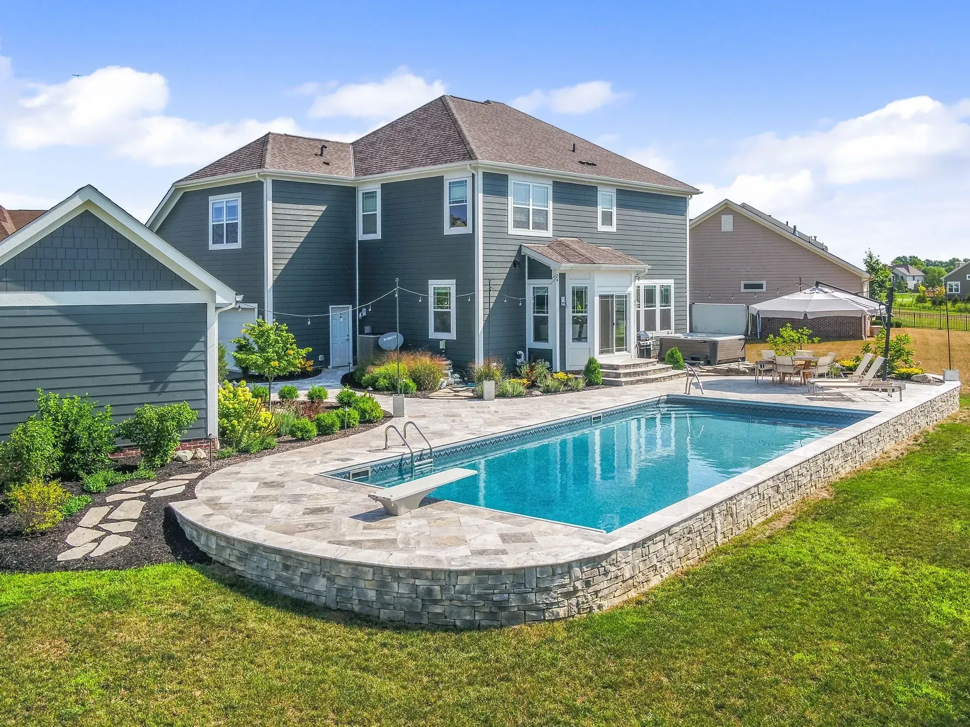 A large house with a large swimming pool in the backyard.