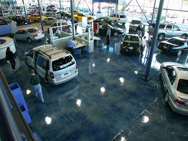 Stained and polished concrete flooring in a car dealership.