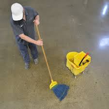 A man cleaning a polished concrete floor.