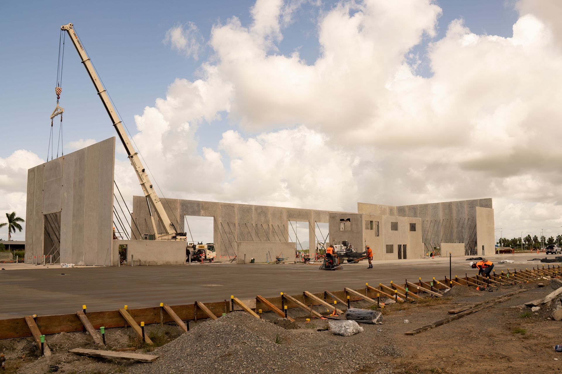 A large building is being built with a crane in the foreground
