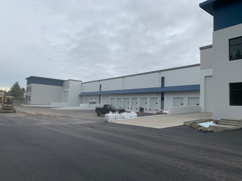 A truck is parked in front of a large building.