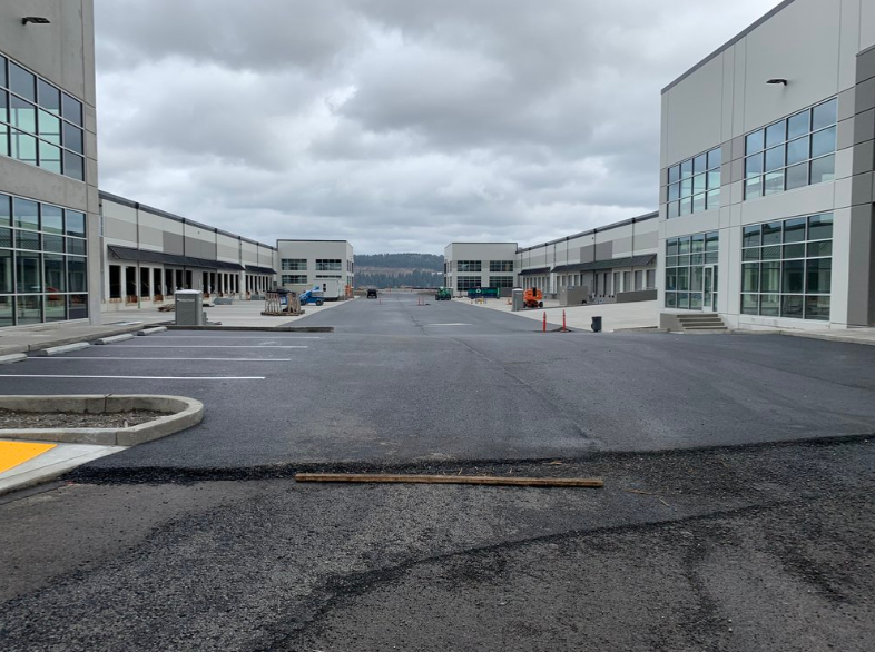 A parking lot with a lot of buildings in the background