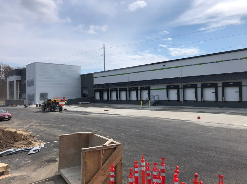 A large white building with a lot of windows is being built.