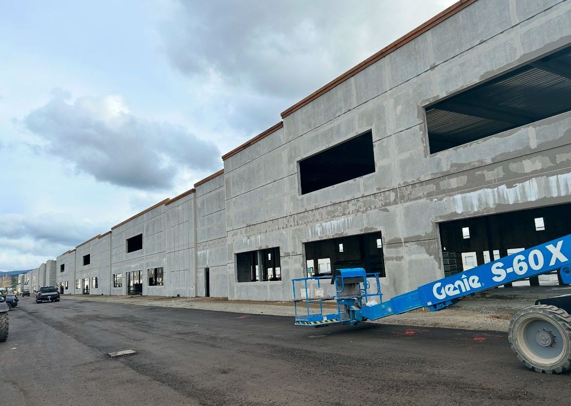 A blue genie s60x is parked in front of a building under construction.