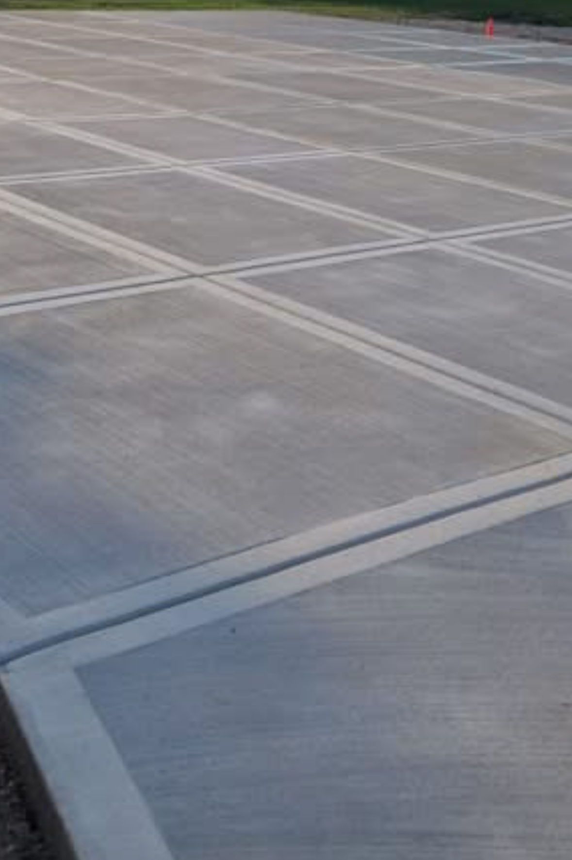 A large concrete parking lot with a lot of lines on it.