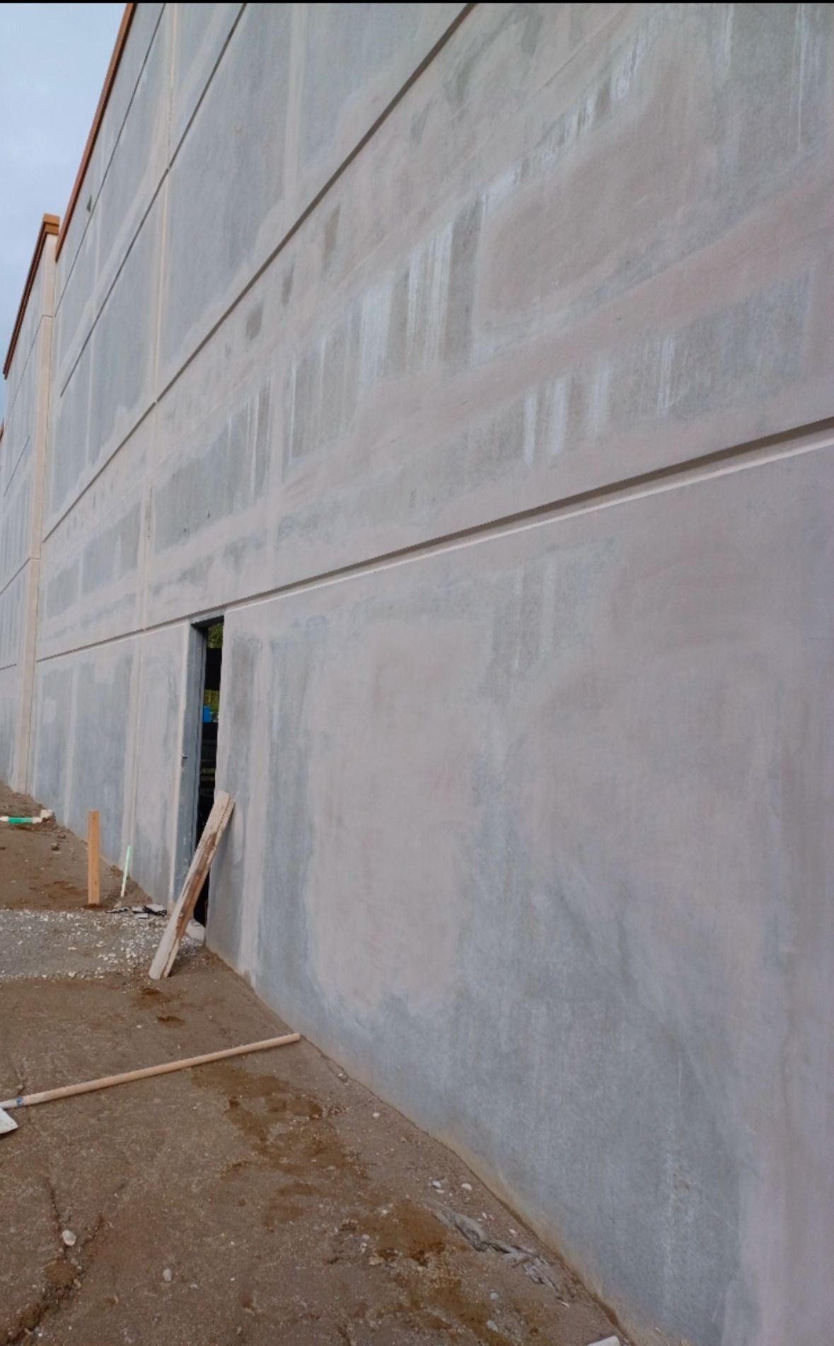 A large concrete wall with a hole in it