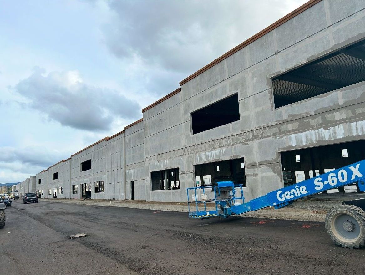A genie s-60x is parked in front of a building under construction