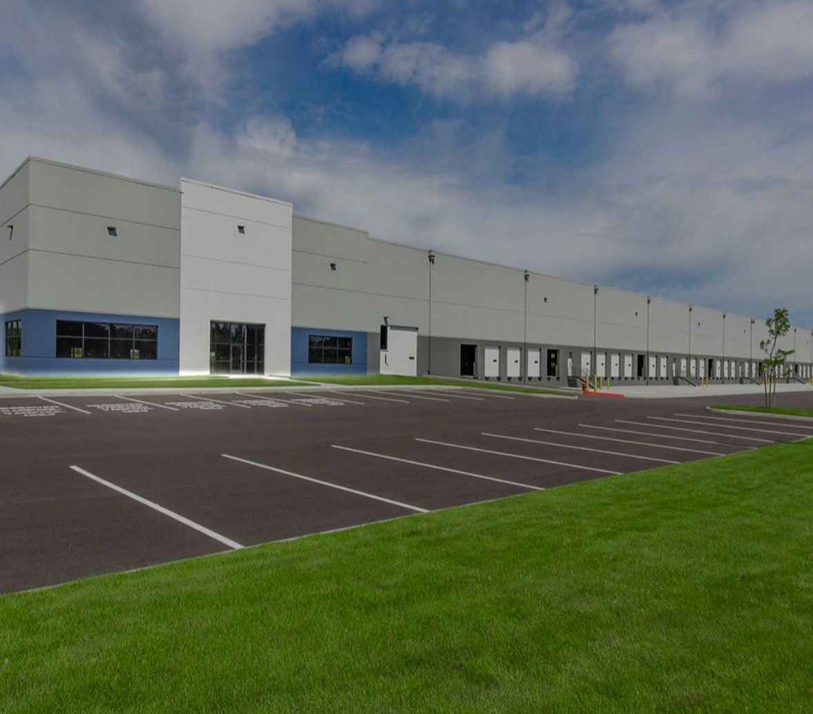 A large building with a parking lot in front of it