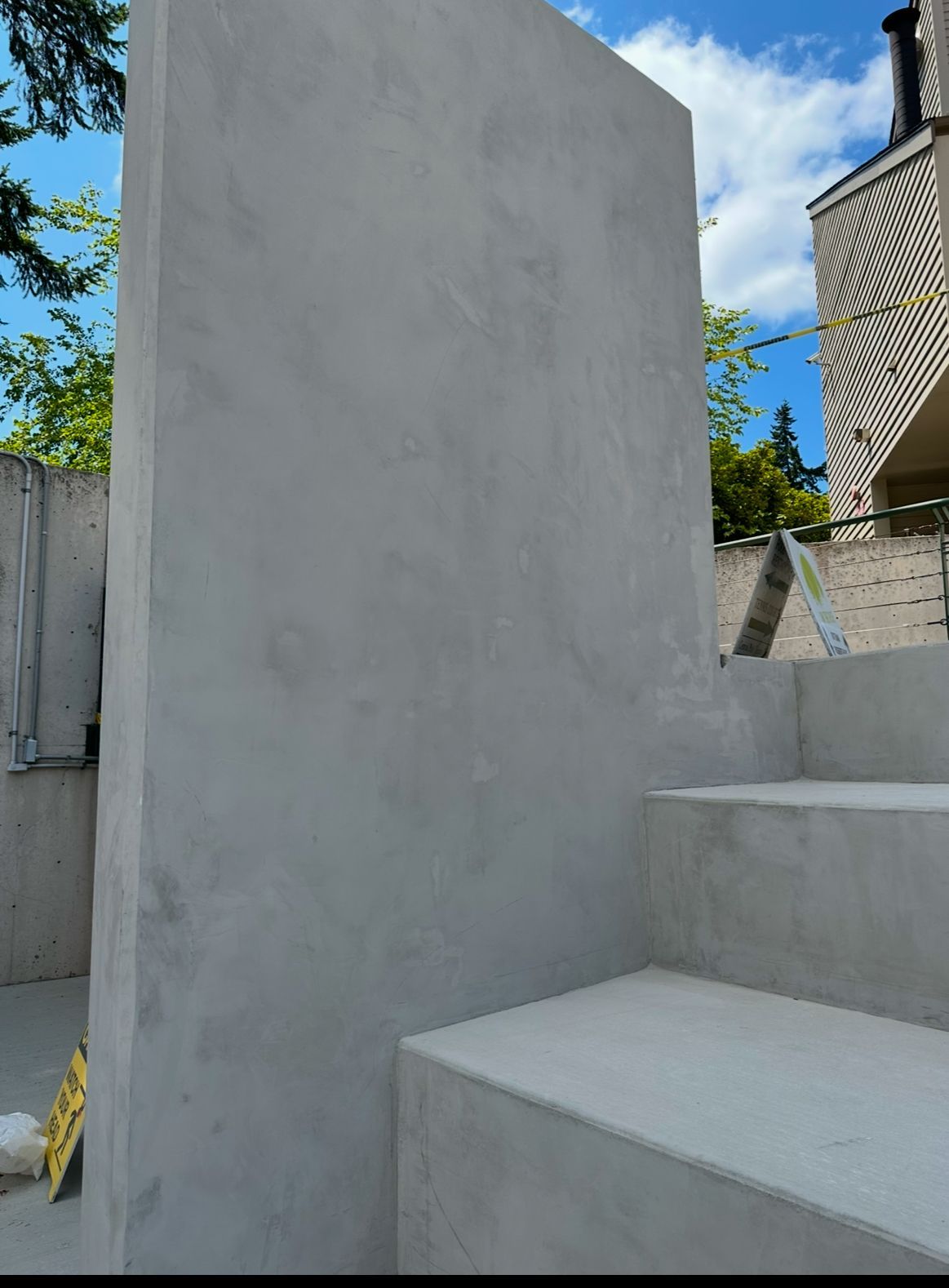 A large concrete wall with stairs in front of it