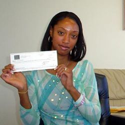 Clarice holding a check