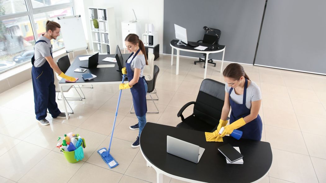 A group of people are cleaning an office.