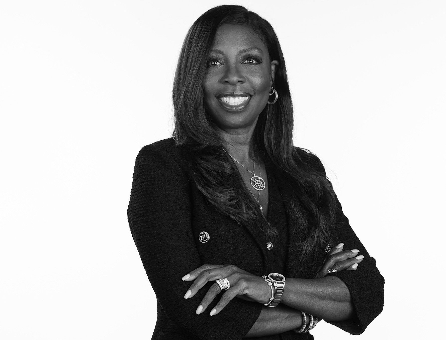 A black and white photo of a woman with her arms crossed