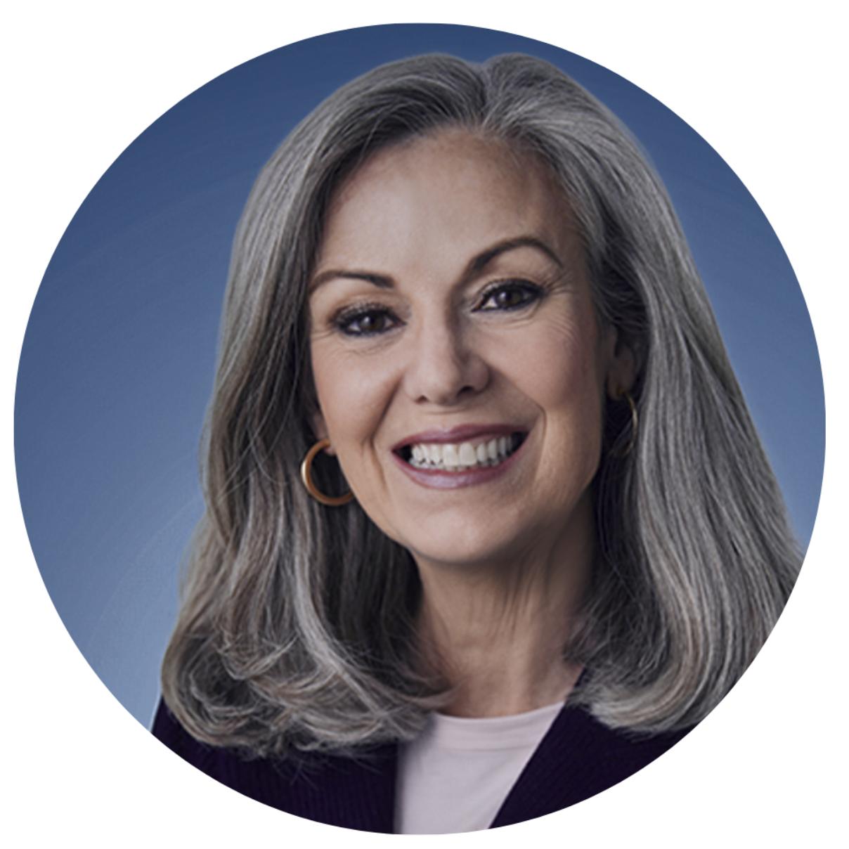 Smiling woman with long gray hair against a blue background
