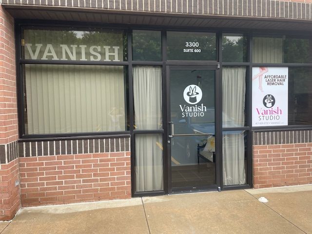 A vanish sign is on a brick building