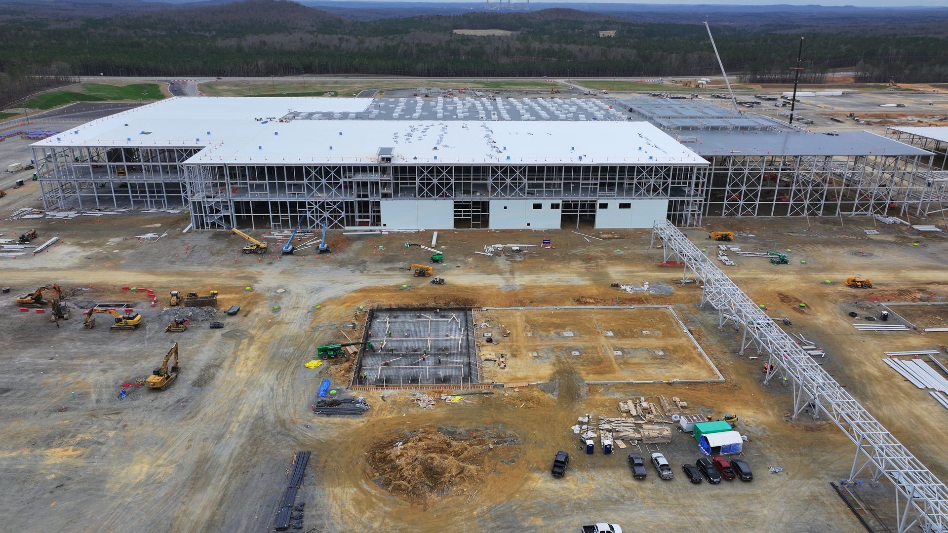 An aerial view of a large building under construction.