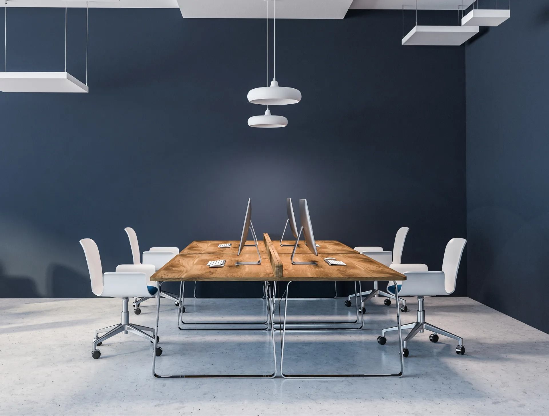 A conference room with a wooden table and white chairs