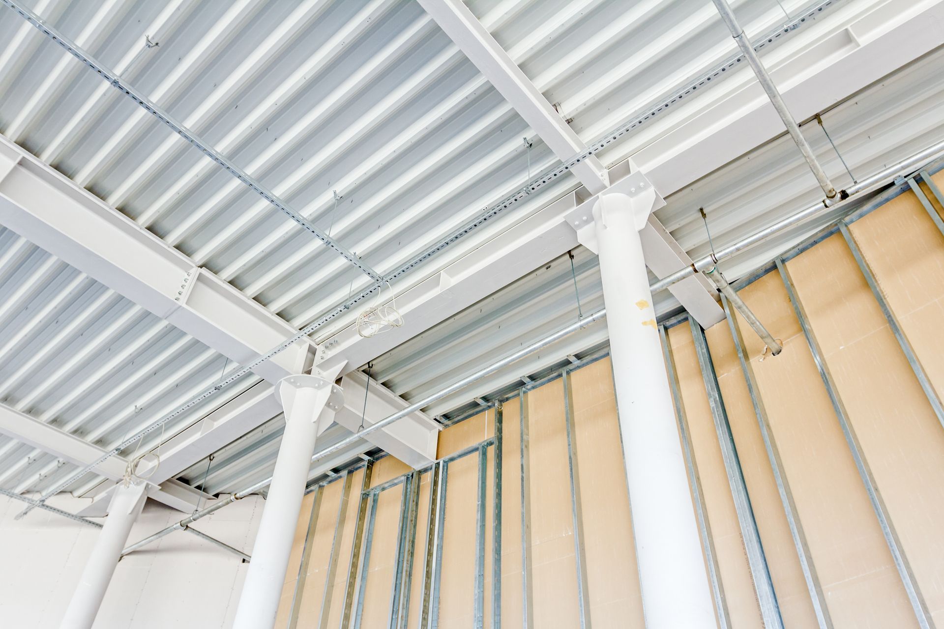 A building under construction with a ceiling and pillars.
