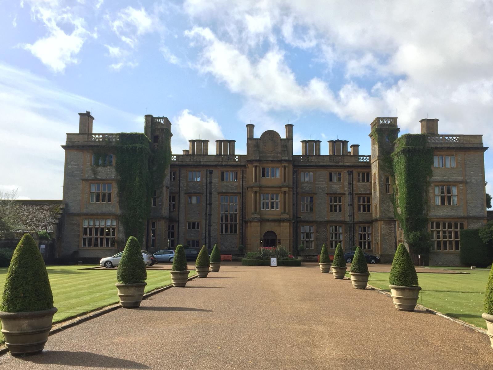 A large building with a gravel driveway leading to it