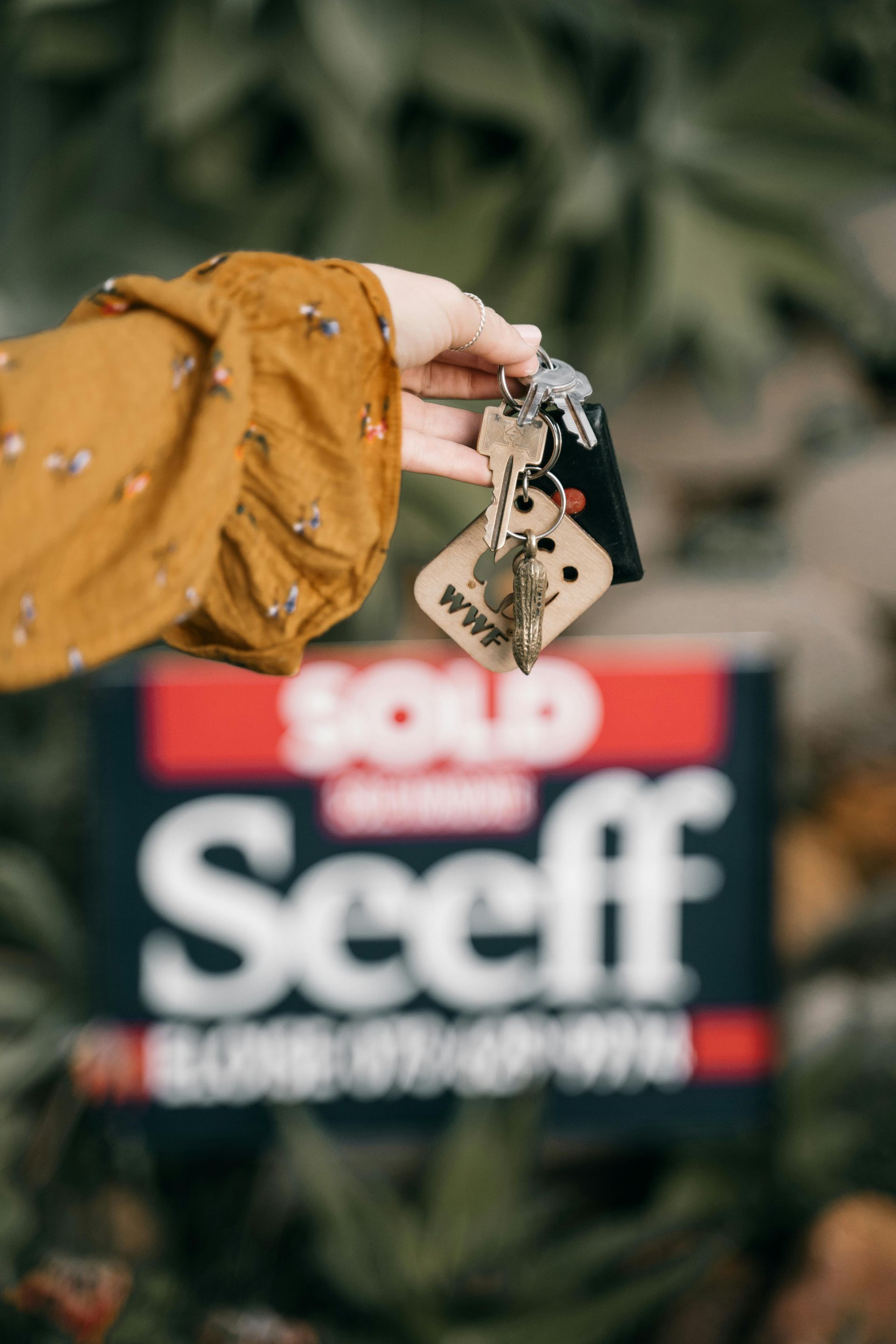Hand holding keys in front of a