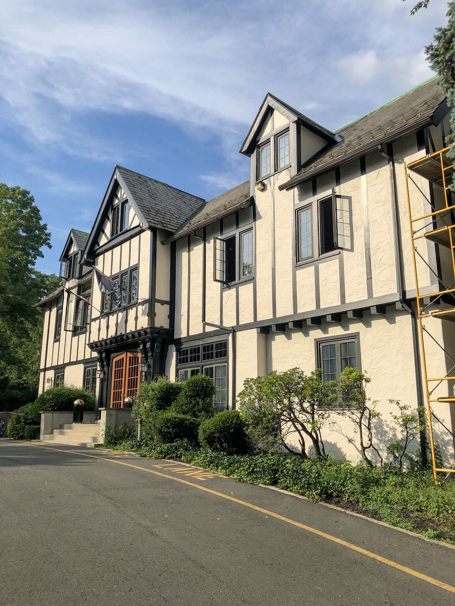 A large white house with a scaffolding in front of it.