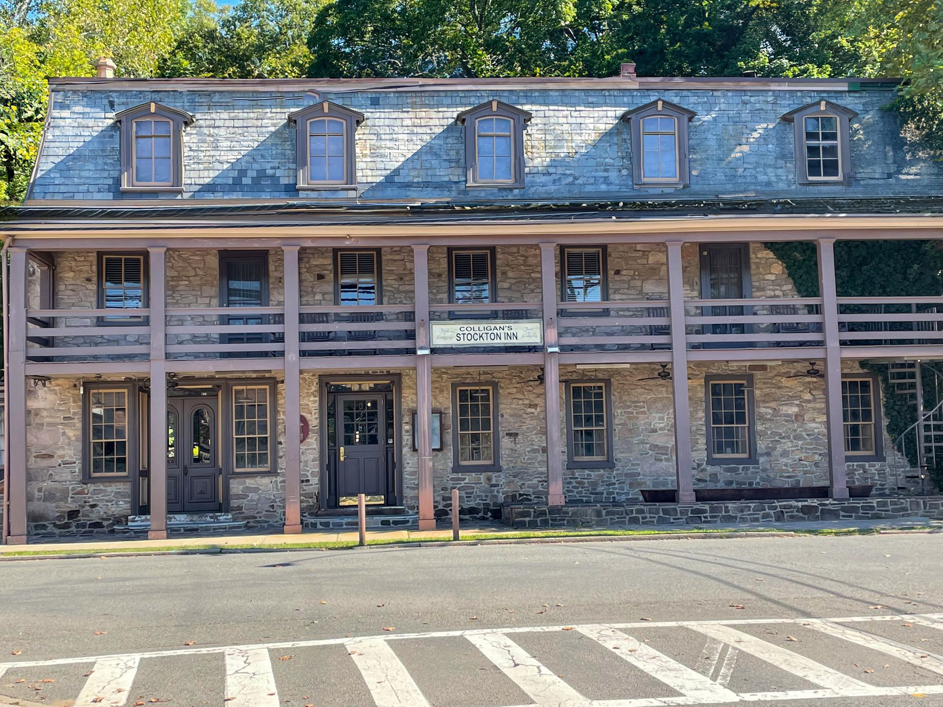 A large stone building with a slate roof and balconies