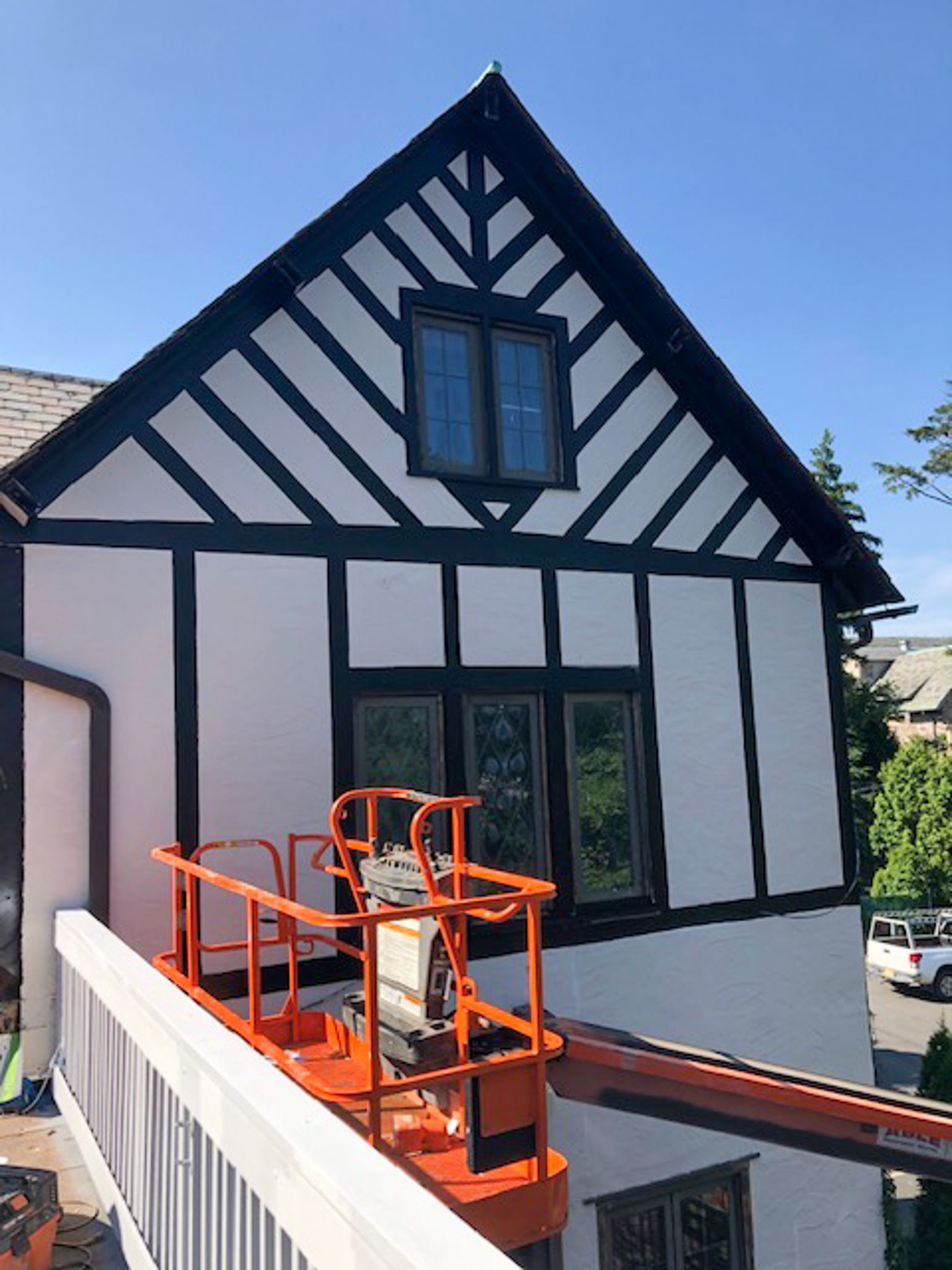 A black and white house with a crane on the side of it.