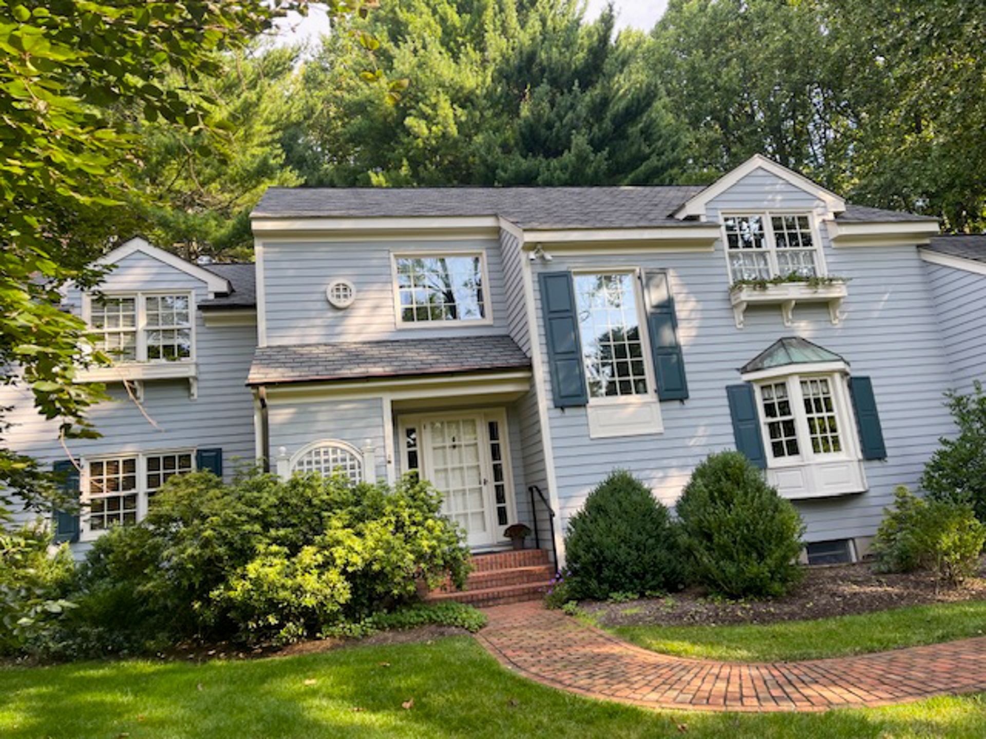 A large house with a lot of windows and blue shutters