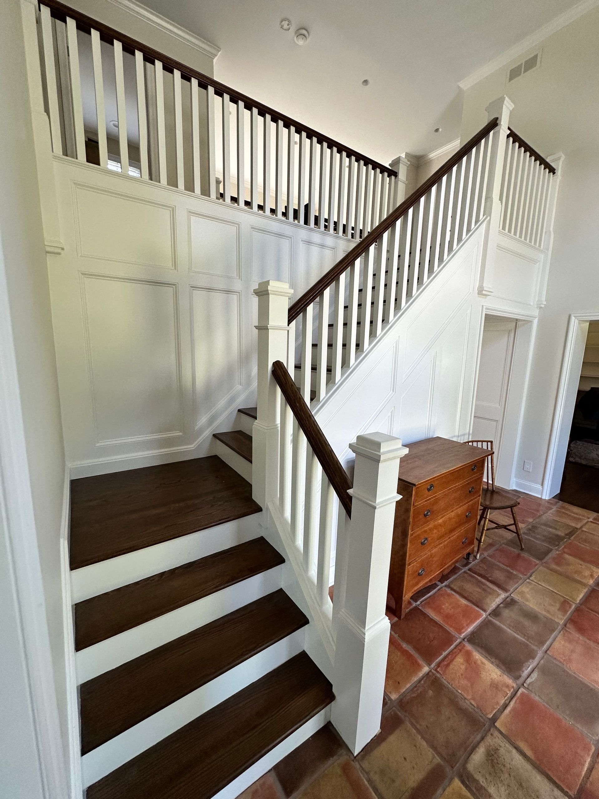 A staircase with wooden steps and a white railing