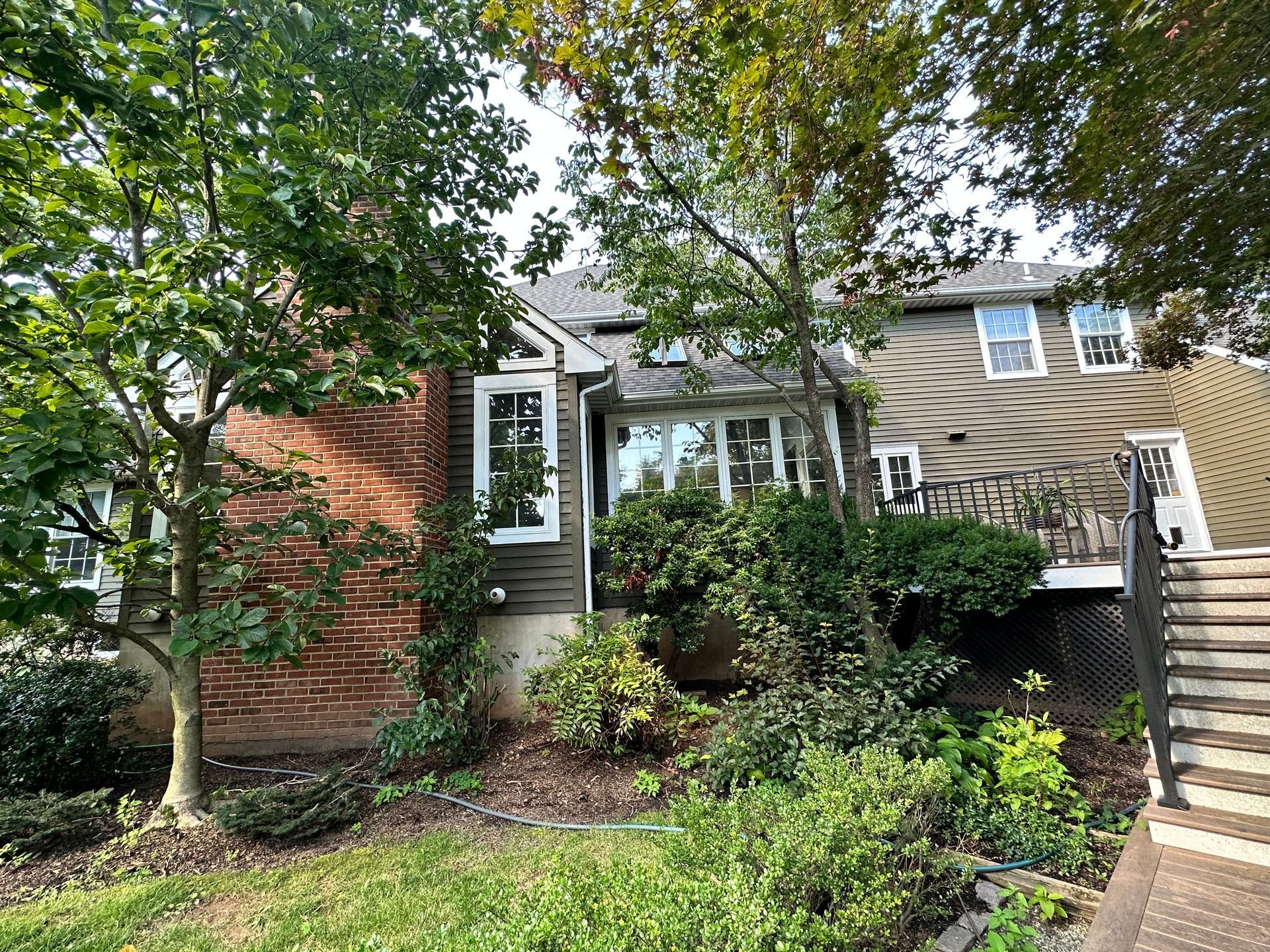 A house with a lot of trees in front of it.