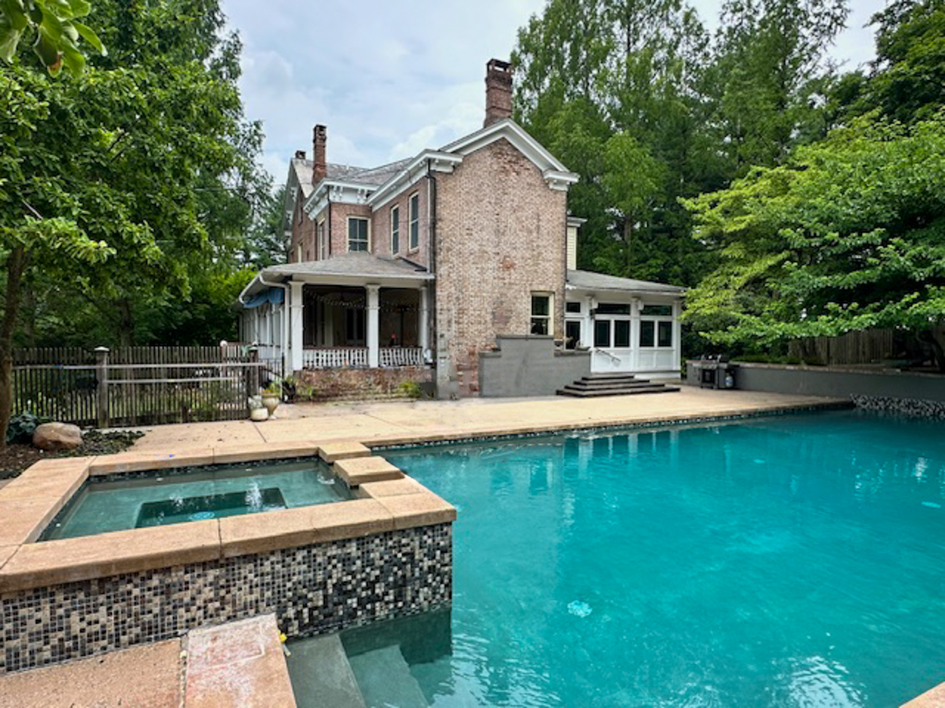 A large house with a large swimming pool in front of it