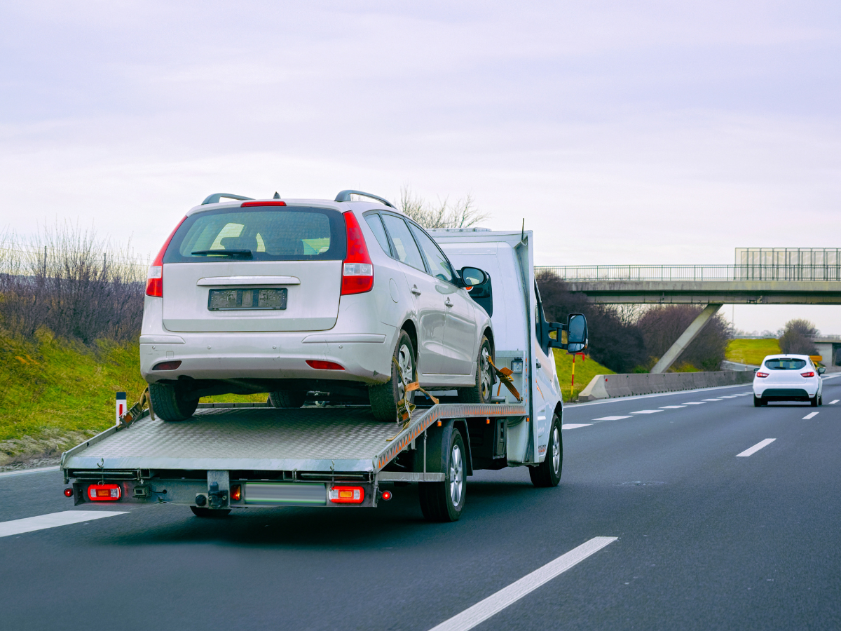 A car beng towed down the highway