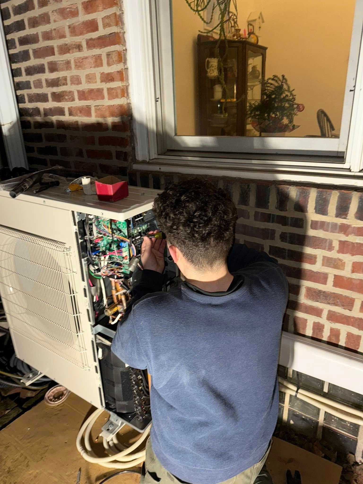 A kitchen with a stainless steel refrigerator, blue toolbox, and tools on the floor.