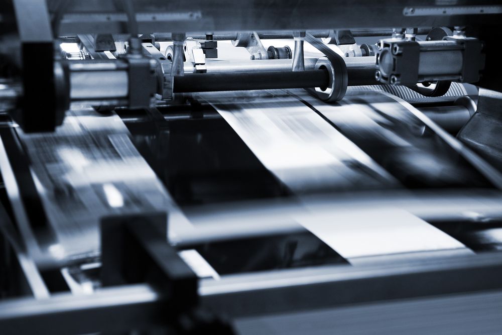 A stack of colorful fabrics sitting on top of a glass table.