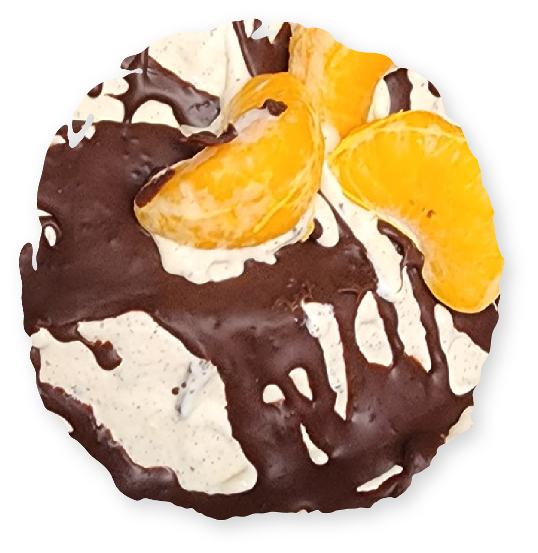 Chocolate dessert with orange slices and cream drizzle.
