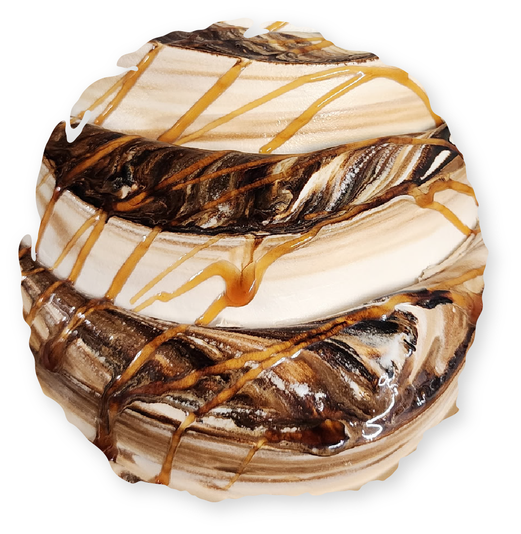 Swirled pastry with layers of brown and tan, drizzled with caramel.