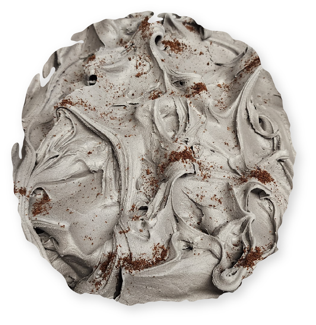 Grey, swirled frosting on a round dessert, dusted with brown flecks.