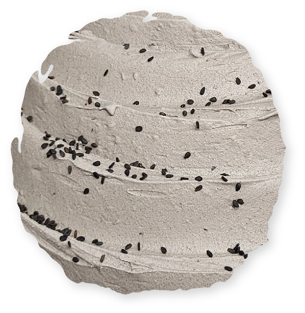 Gray textured surface with black seeds.