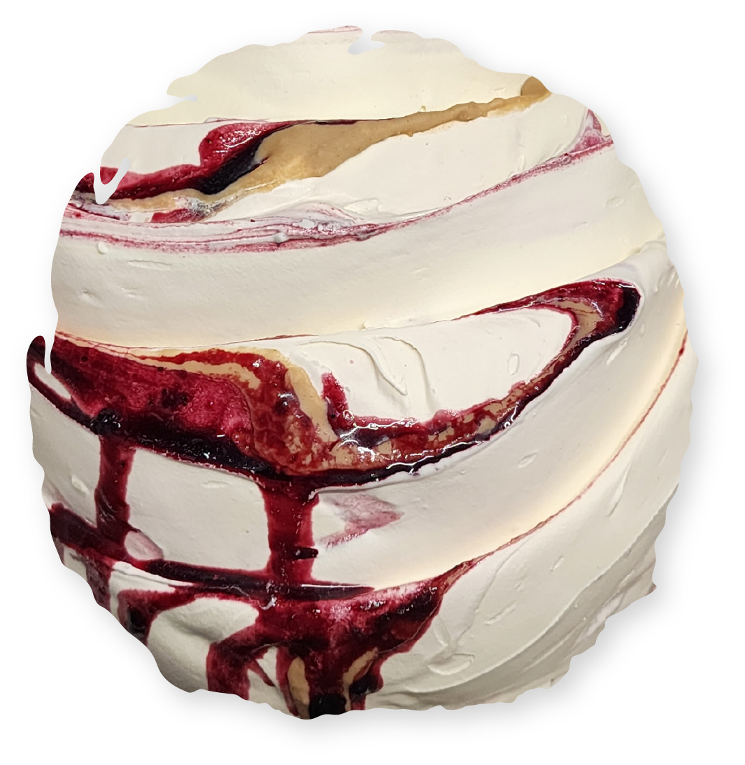 Swirled white dessert with berry sauce and caramel drizzle.